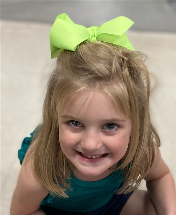 Picture of a student wearing green and happy